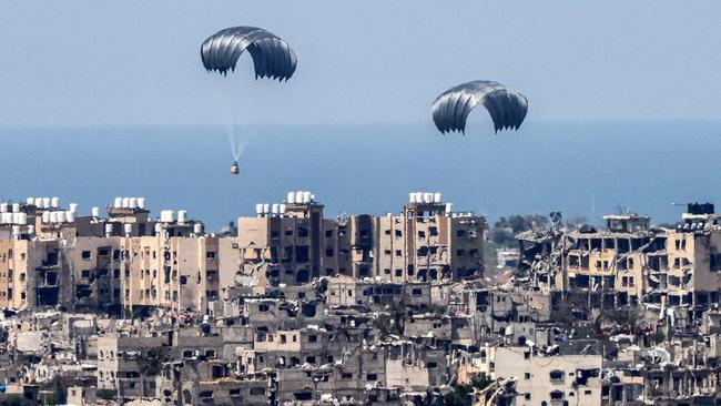 Parachutes of humanitarian aid dropping over the besieged Palestinian territory. Picture: AFP