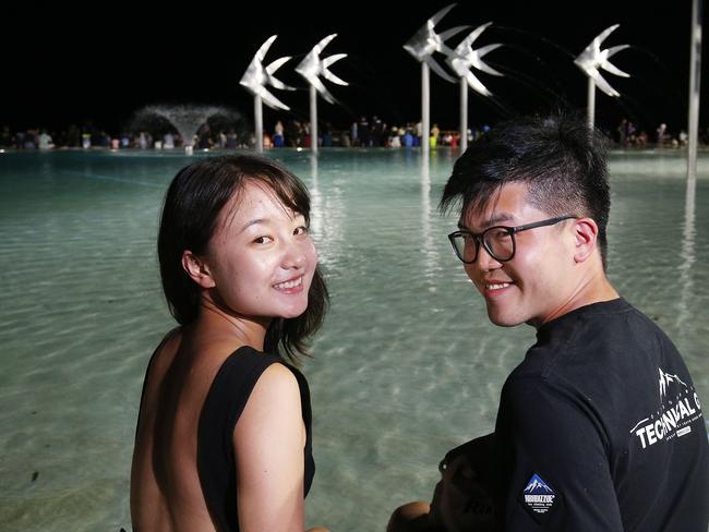 Alice and Kai Wang find a great spot to watch the fireworks on New Year's Eve on the Cairns Esplanade. Picture: Brendan Radke