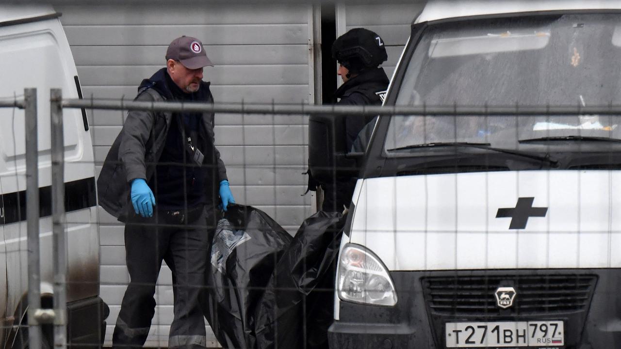 Law enforcement officers carry out the body of a victim. Picture: Olga Maltseva / AFP