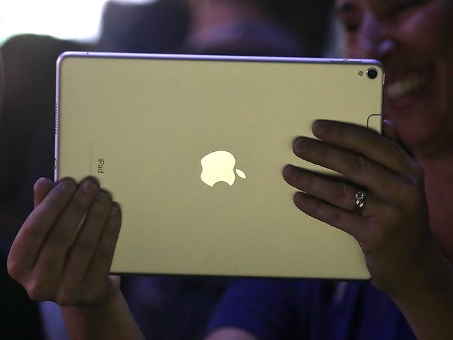 SAN JOSE, CA - JUNE 05: Attendees inspect the new iPad Pro during the 2017 Apple Worldwide Developer Conference (WWDC) at the San Jose Convention Center on June 5, 2017 in San Jose, California. Apple CEO Tim Cook kicked off the five-day WWDC with announcements of a a new operating system, a new iPad Pro and a the HomePod, a music speaker and home assistant. WWDC runs through June 9.   Justin Sullivan/Getty Images/AFP == FOR NEWSPAPERS, INTERNET, TELCOS & TELEVISION USE ONLY ==