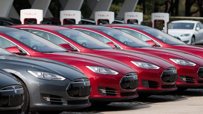 To go with AFP story China-auto-show-environment-Tesla,FOCUS by Bill Savadove This picture taken on March 17, 2015 shows Tesla Model S vehicles parked outside a car dealership in Shanghai. Serial entrepreneur Elon Musk has launched spacecraft into orbit, but popularising his Tesla electric cars in China is proving to be tougher than rocket science. AFP PHOTO / JOHANNES EISELE