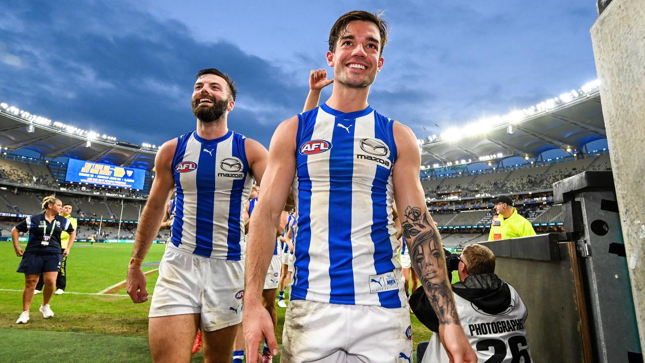 PERTH, AUSTRALIA - JUNE 08: Jy Simpkin of the Kangaroos leads his team to the rooms after the win during the 2024 AFL Round 12 match between the West Coast Eagles and the North Melbourne Kangaroos at Optus Stadium on June 08, 2024 in Perth, Australia. (Photo by Daniel Carson/AFL Photos via Getty Images)