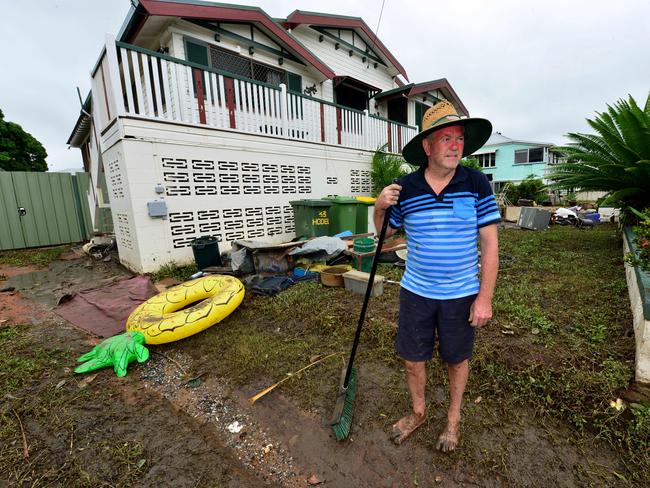 Townsville Floods. Hermit Park resident Kevin Warren helps clean his neighbour's Hodel Street home. Picture: Evan Morgan