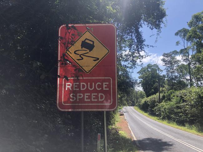 A reduce speed sign with the slippery when wet logo on Fagans Rd, Lisarow, was erected there after a string of similar accidents where cars lost control and hit the same power pole or left the road nearby. Picture: Richard Noone