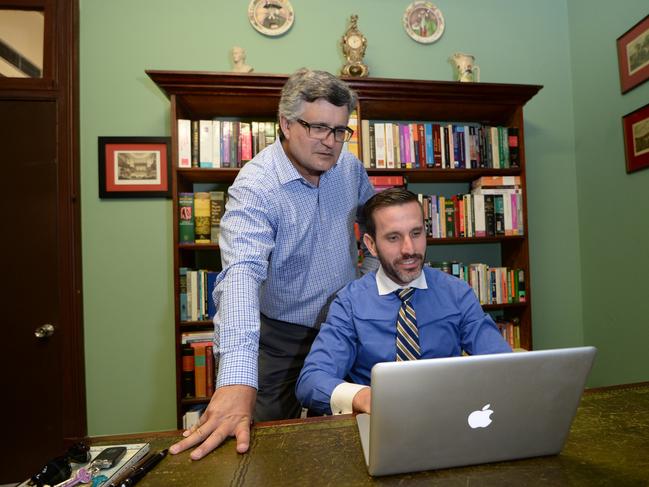 Barristers Ross Lo Monaco and Jordan Ahlstrand search for photos taken in the old Rockhampton Supreme Court building showing "Orbs" which denote the presence of spirits. Photo: Chris Ison / The Morning Bulletin