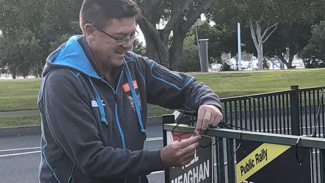 Southport MP Rob Molhoek putting up placards in Carey Park.