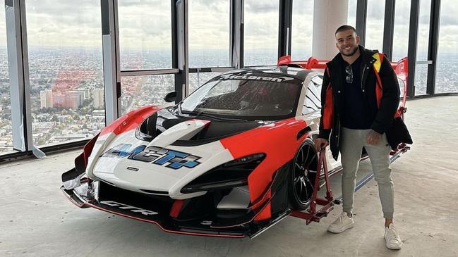 Portelli poses with the McLaren Senna GTR after it was successfully lifted into his penthouse apartment. Image supplied.