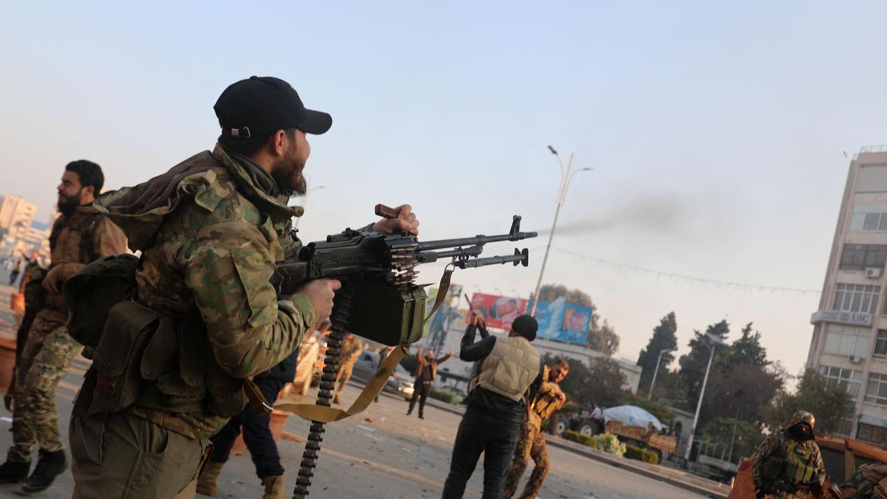 A Syrian rebel fires into the air to celebrate the capture of the city of Hama. Picture: Abdulaziz Ketaz/AFP