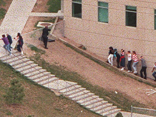 Aerial view of students being led from Columbine High School.