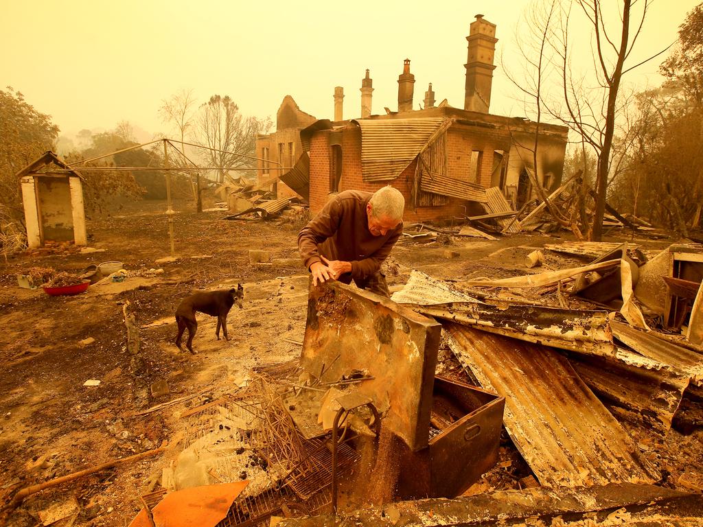 Malcolm Elmslie sifts through the remnants of his house in Cobargo after the firestorm swept through on New Year's Eve. Picture: Stuart McEvoy