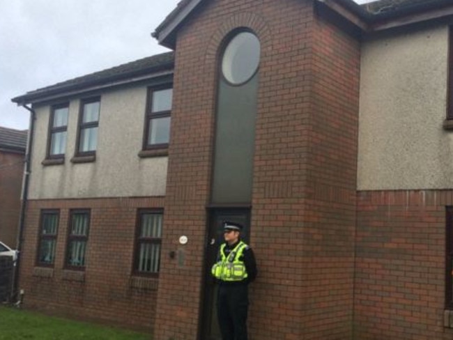 Police guard the block of flats where John Sabine’s body was found. Picture: WALES NEWS SERVICE