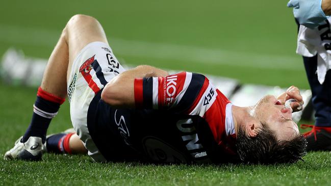 Luke Keary writhes in pain after copping a hit to the ribs during loss to the Melbourne Storm at the SCG on Thursday night. Picture: Phil Hillyard