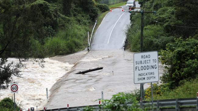 Floodwaters wash over a bridge on Clagiraba Road, Clagiraba, west of the Gold Coast. Picture: Nigel Hallett