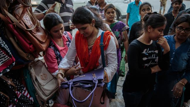 Women shop in a Mumbai market. Indian IT operators earn about 10 per cent of their Australian counterparts.