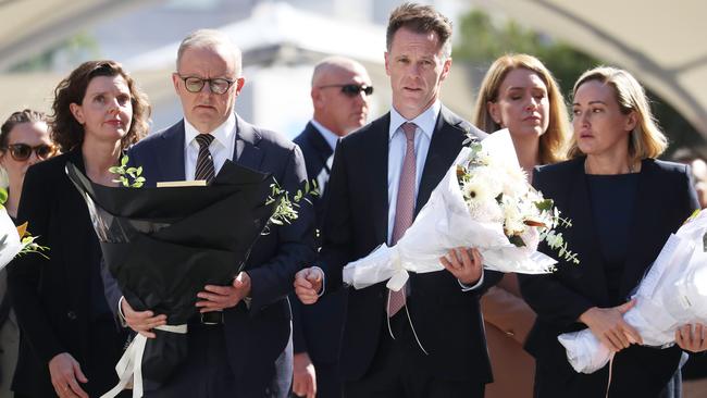 Prime Minister Anthony Albanese and NSW Premier Chris Minns leave flowers at Bondi Junction after six people were stabbed and killed in the shopping centre on Saturday. Picture: John Feder/The Australian