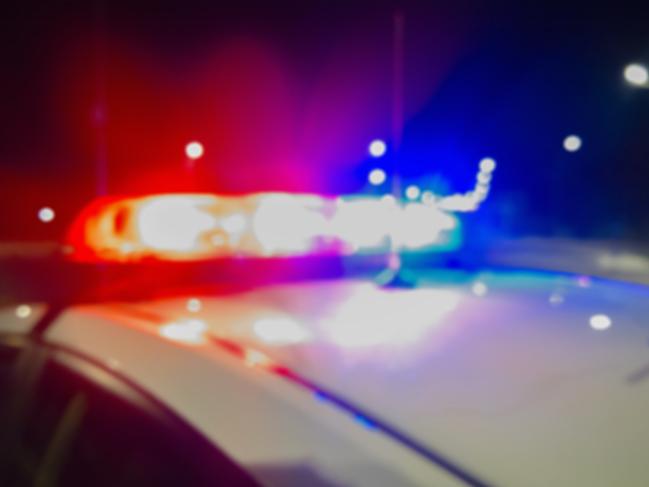 Red and blue Lights of police car in night time. Night patrolling the city. Abstract blurry image.