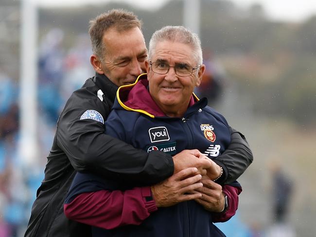 ADELAIDE, AUSTRALIA - APRIL 15: Chris Fagan, Senior Coach of the Lions and Alastair Clarkson, Senior Coach of the Kangaroos embrace before the 2023 AFL Round 05 match between the Brisbane Lions and the North Melbourne Kangaroos at Adelaide Hills on April 15, 2023 in Adelaide, Australia. (Photo by Michael Willson/AFL Photos via Getty Images)