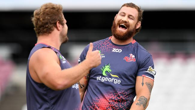 Reds captain Scott Higginbotham enjoys a laugh with teammate James Slipper at training.