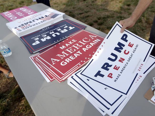 People choose signs to hold as they arrive for a rally for Republican presidential candidate Donald Trump Thursday, Nov. 3, 2016, in Selma, N.C. (AP Photo/John Bazemore)