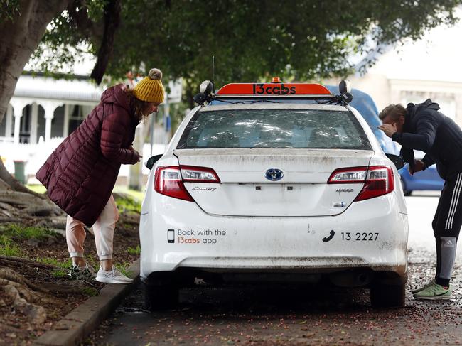 Local residents inspect a dumped taxi in Burt St, Rozelle. Picture: Sam Ruttyn