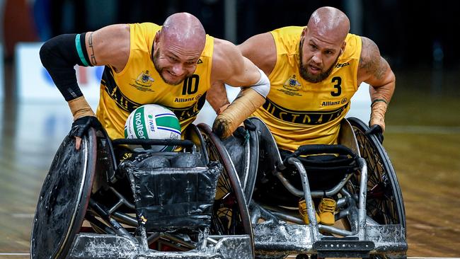 Chris Bond (left) and Ryley Batt of Australia are seen pushing towards the try line against New Zealand during the Pool A match between Australia and New Zealand at the GIO 2018 IWRF Wheelchair Rugby World Championships at the QuayCentre in Sydney, Sunday, August 5, 2018. (AAP Image/Brendan Esposito)