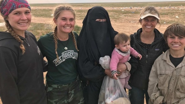 Australian woman Zehra Duman (centre) holding her daughter with aid workers from the Free Burma Rangers in Syria. Picture: Supplied