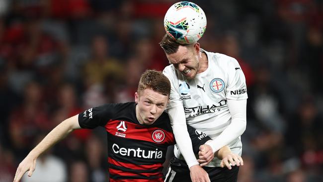 Craig Noone of Melbourne City competes with the Daniel Wilmering of the Wanderers during their match in round seven.