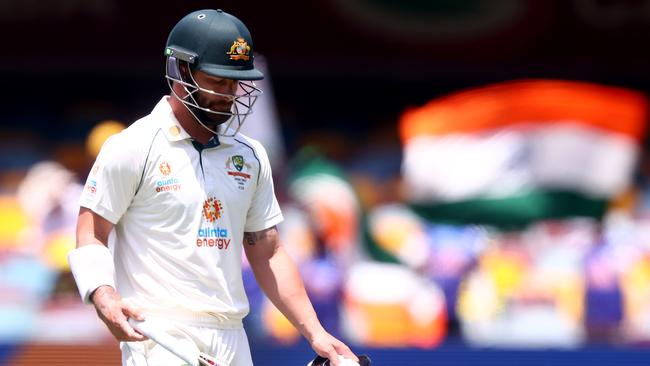 Australia's batsman Matthew Wade departs after his dismissal off India's paceman Mohammed Siraj on day four of the fourth cricket Test match between Australia and India at The Gabba in Brisbane on January 18, 2021. (Photo by Patrick HAMILTON / AFP)