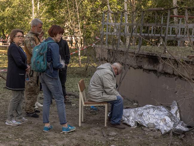 A man mourns over the body of his granddaughter killed during a Russian missile attack, next to a damaged clinic in Kyiv, Ukraine. Picture: Getty Images