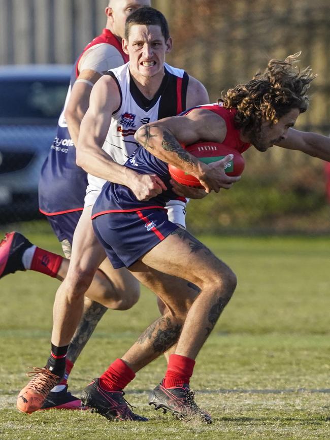 SFNL: Chelsea Heights’ Ryan Odell is wrapped up by Shaun Walsh of Hampton Park. Picture: Valeriu Campan