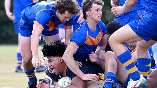 Iona’s Leota Hope scores for his side against Ashgrove. The picture says it all - four Ash bodies around the big bloke and still he could not be stopped. Picture, John Gass