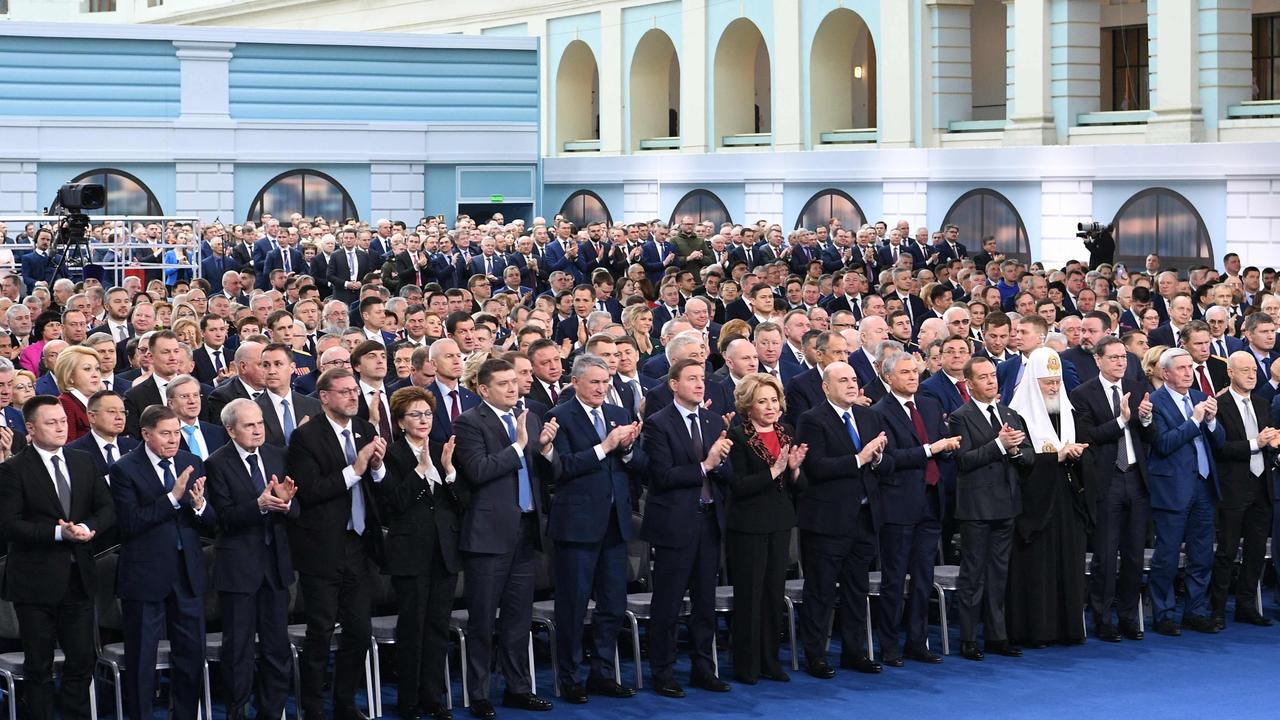 Attendees applaud as Russian President Vladimir Putin delivers his annual state of the nation address at the Gostiny Dvor conference centre in central Moscow on February 21, 2023. (Photo by Maksim BLINOV / SPUTNIK / AFP)