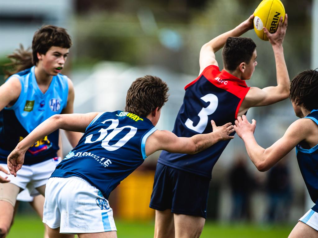 STJFA Grand Finals: North Hobart v Lindisfarne U14A1 Darcy Goodwin of Lindisfarne, reaches out to Jed Bricknell of North Hobart Picture: Linda Higginson