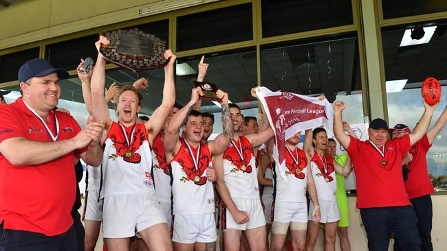 Flagstaff Hill players and coaches are presented with their flag and premiership trophy. Picture: AAP/Keryn Stevens