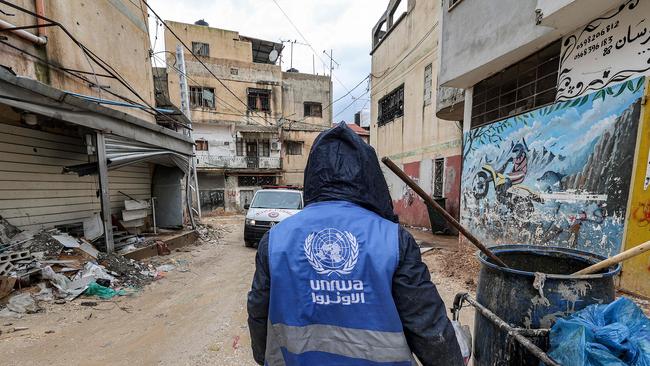 A United Nations Relief and Works Agency worker collects rubbish in the city of Jenin, in the occupied West Bank. Picture: AFP