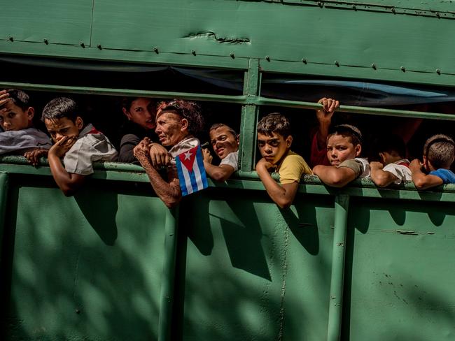 Daily Life - First Prize, Stories © Tomas Munita, for The New York Times Title: Cuba On The Edge Of Change Trucks carried students home after the carriage carrying Fidel’s ashes passed in Las Tunas Province, Cuba. Cuba declared nine days of mourning after Fidel Castro’s death, a period that culminated with his funeral. For many, the death of Fidel Castro felt like that of a father.