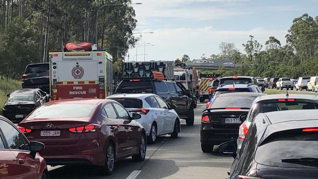 Paramedics, police, and fire trucks are at the scene of a truck rollover in Gaven. Picture: Supplied