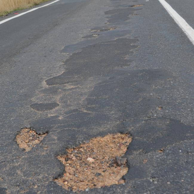 Potholes on major roads such as the New England Hwy, south of the Bracker Rd intersection. Picture: Georja Ryan