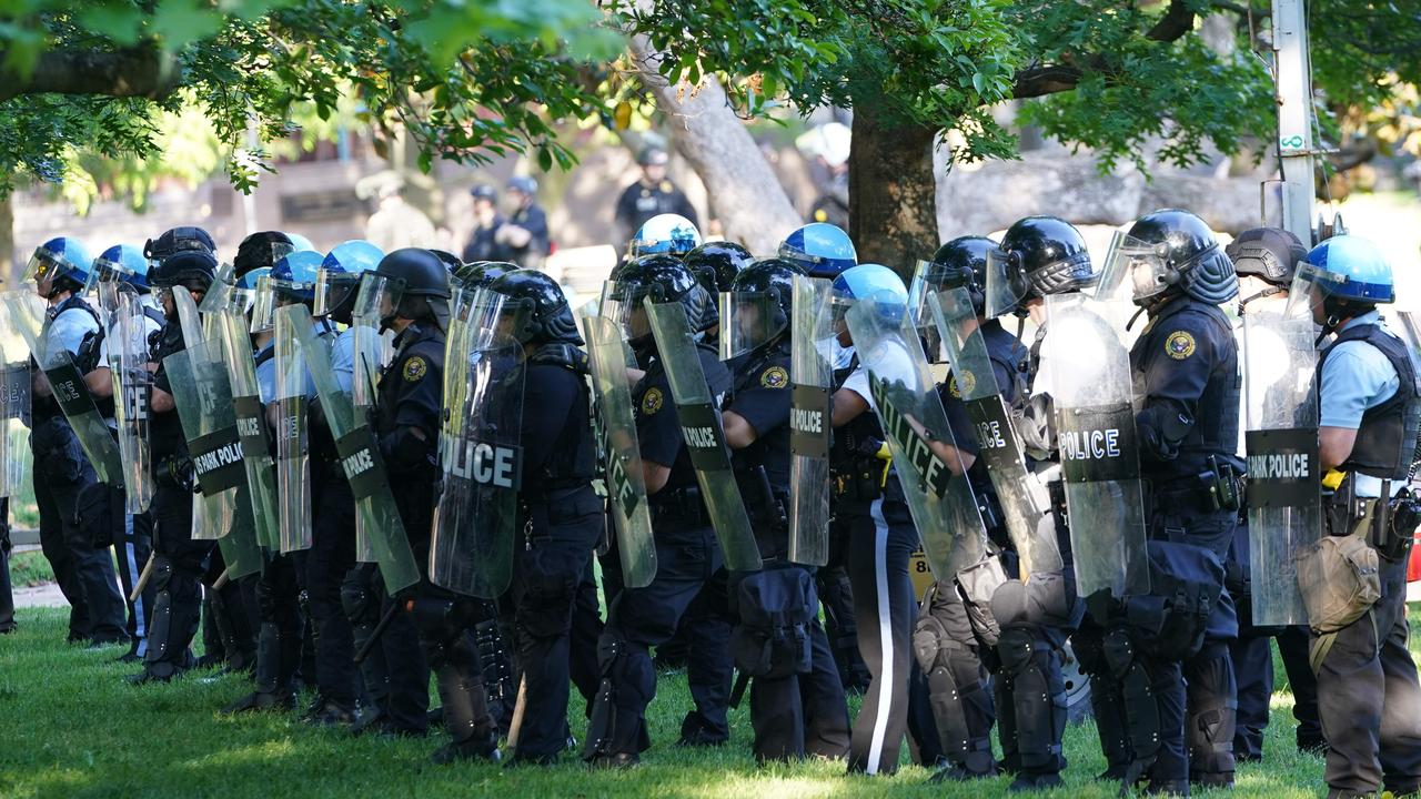 Police watch demonstrators protesting the death of George Floyd near the White House.