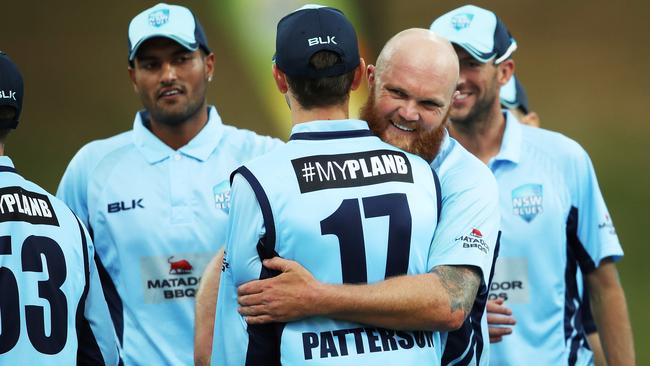 NSW fast bowlers Doug Bollinger hugs teammate Kurtis Patterson after taking the wicket of South Australia’s Tim Ludeman on Wednesday.
