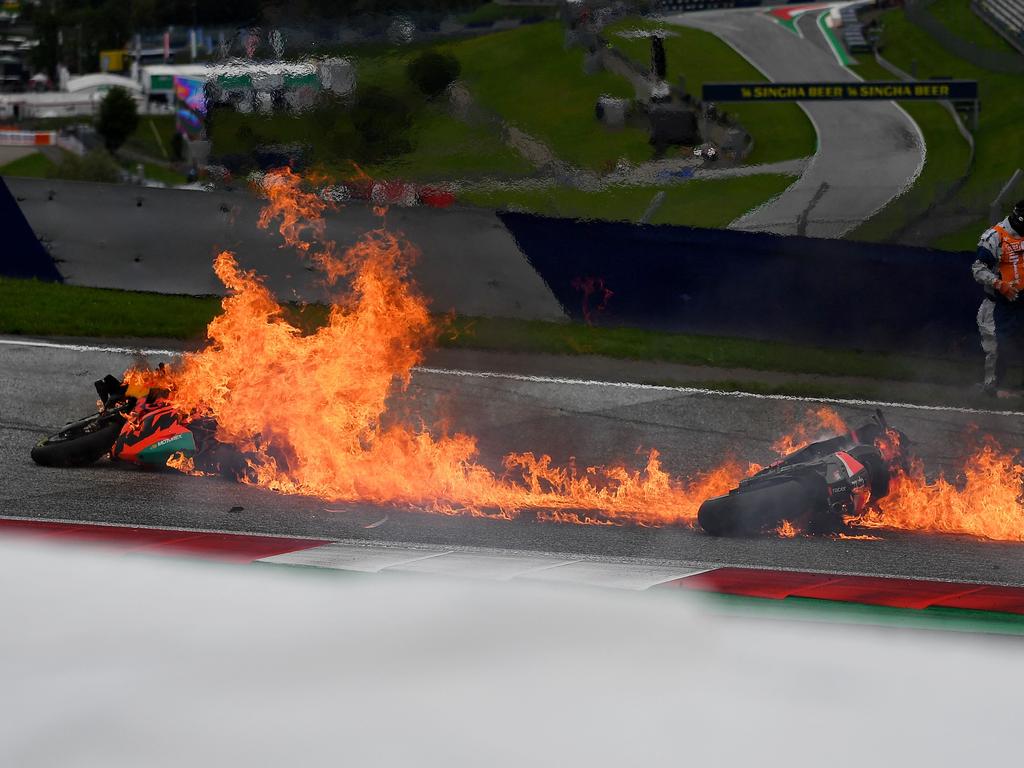 Motorbikes are on fire following a crash involving Aprilia Italian rider Lorenzo Savadori and KTM Spanish rider Dani Pedrosa.