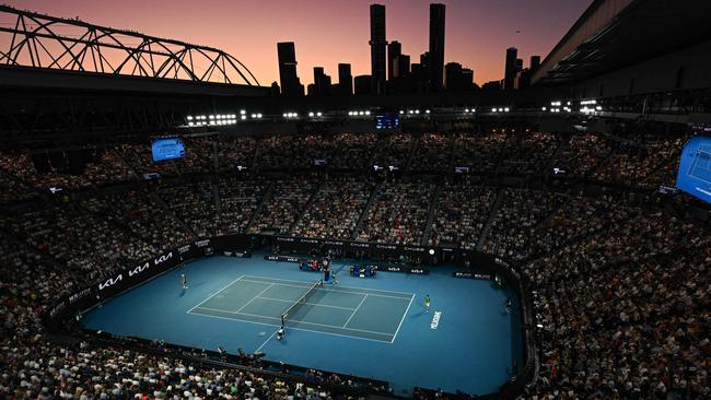 Spectators watch men's singles final match between Italy's Jannik Sinner (L) and Russia's Daniil Medvedev (R) on day 15 of the Australian Open tennis tournament in Melbourne on January 28, 2024. (Photo by Paul Crock / AFP) / -- IMAGE RESTRICTED TO EDITORIAL USE - STRICTLY NO COMMERCIAL USE --