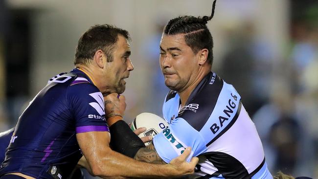 Andrew Fifita (R) is tackled by Cameron Smith. Photo: Getty Images