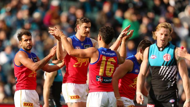 Brisbane players celebrate one of their 23 goals for the day. (Photo by Sarah Reed/AFL Photos via Getty Images)