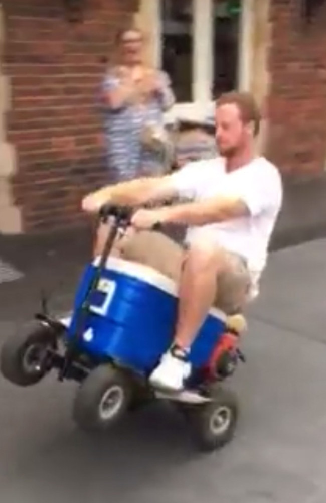 A screen grab from a video posted on the Facebook page of Camden Hotel showing James Wallace riding a motorised esky. Picture: Facebook