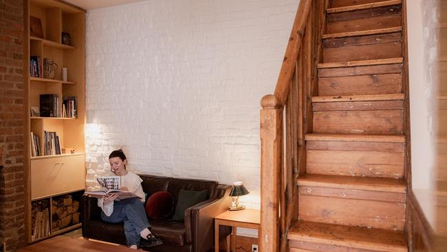 The cosy living room of the Little Brick Cottage, with the stairs leading up to the original attic bedroom. Picture: Rosie Hastie.