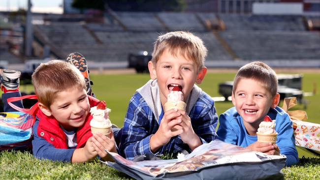 Mitchell, Toby, and Zachary Wilson eat strawberry sundaes in preparation for the first release of Ekka ticket sales on Friday. Picture: Steve Pohlner