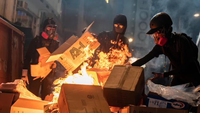 Pro-democracy protesters set a barricade on fire during a demonstration in Causeway Bay district.