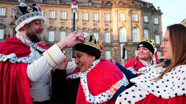 Pedesitrans dress as royals at Christiansborg Palace Square before the proclamation of abdication of Denmark's Queen Margrethe II, in Copenhagen, on Sunday. Picture: Mads Claus Rasmussen/Ritzau Scanpix/AFP