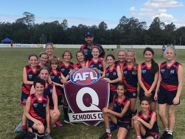 Hillcrest Christian College won the primary female division of the AFLQ Schools Cup SEQ South competition. Pictured with coach Matthew Lappin. Picture: Supplied.